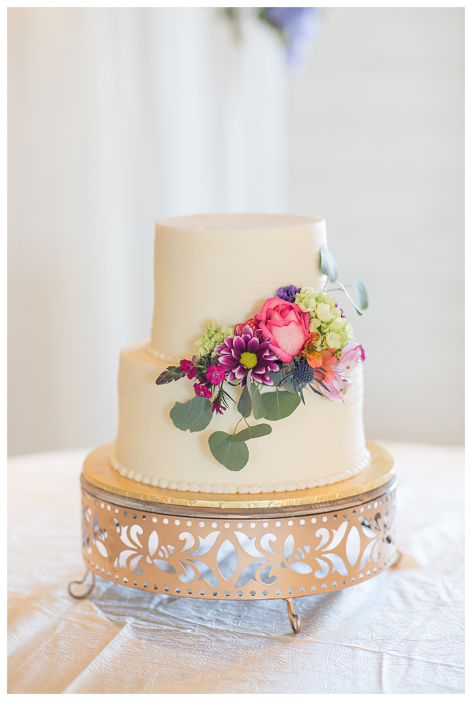 wedding cake, tiered with flowers on table