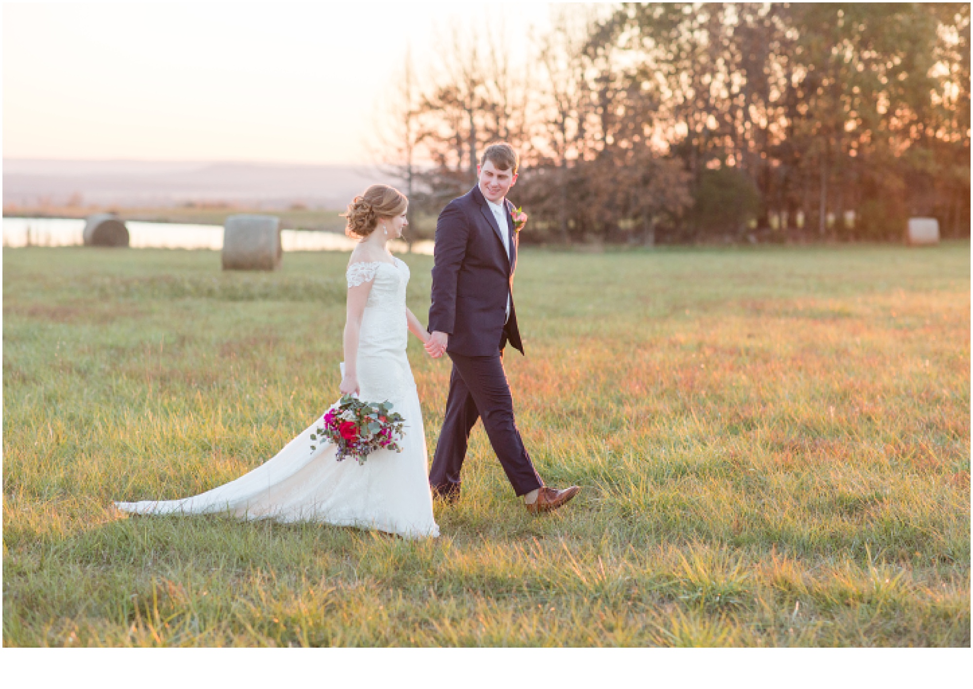 bride and groom white dress, navy blue suit walking in field, wedding flowers in hand