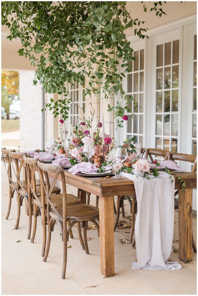 tablescape filled with wooden chairs, purple and cream colors.