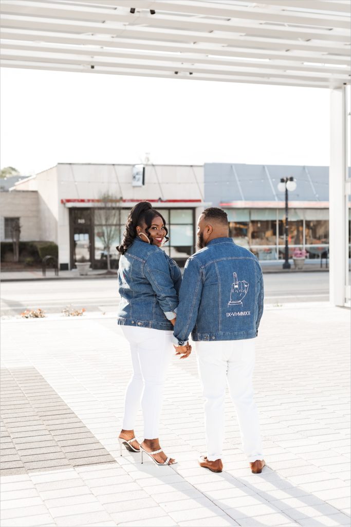 man and woman smiling at each other during their little rock arkansas engagement session