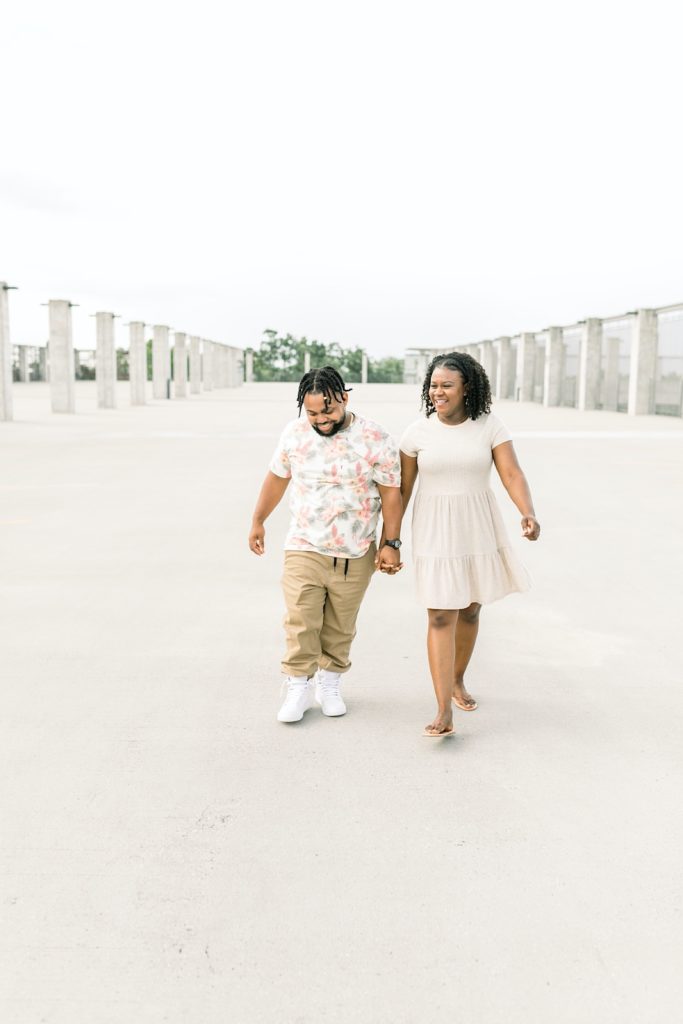 man and woman walking during their fayetteville arkansas engagement session