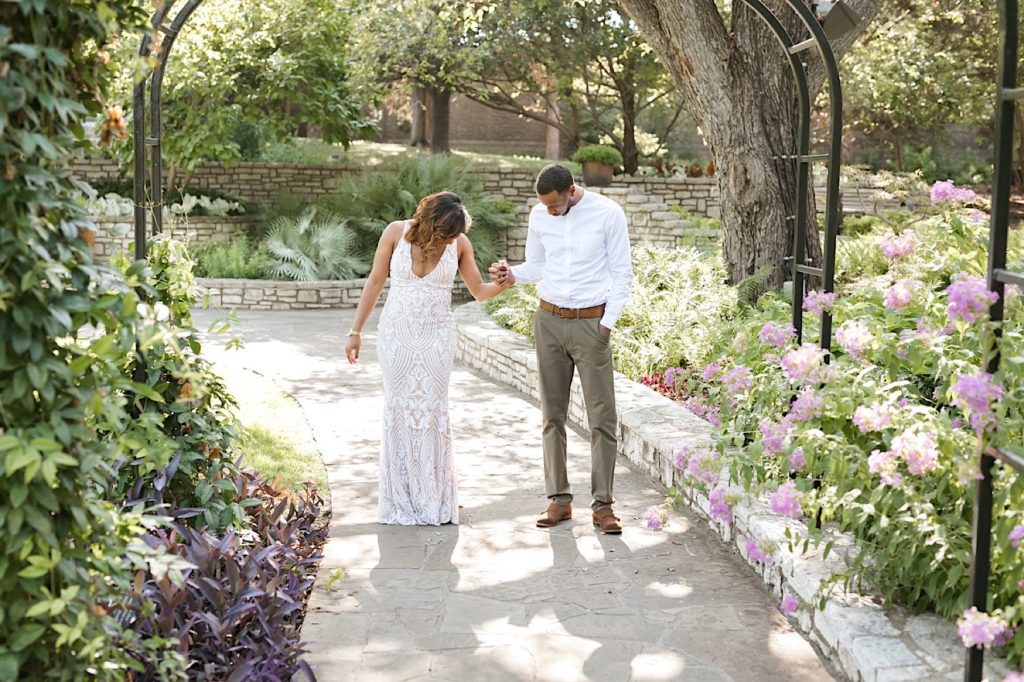 man and woman enjoying each other during their forth worth botanical gardens engagement session in dallas fort worth texa