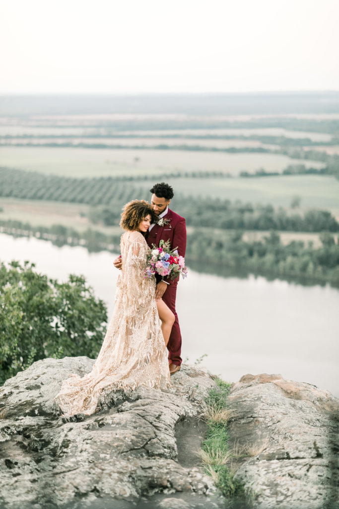 bride and groom standing on bluff during their petit jean mountain state park elopement