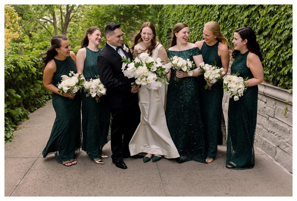 bridal party dressing in hunter green dresses from Adrianna Papell and suit from Jos A Banks during wedding at Windsor at Hebron Park in Carrollton Dallas, Texas
