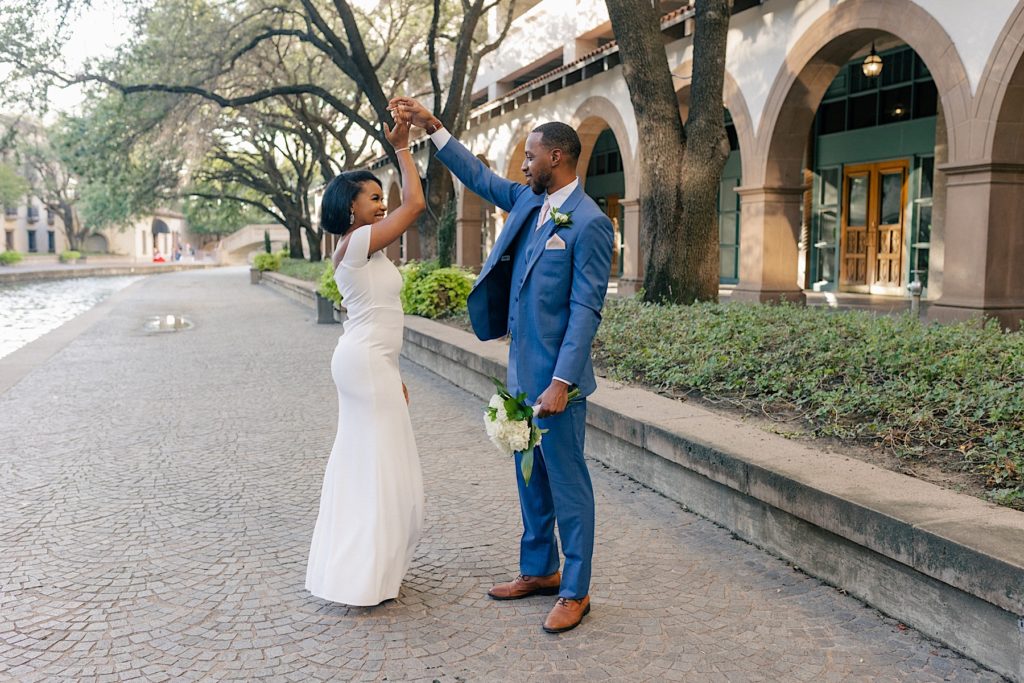 bride and groom twirling during their dallas wedding