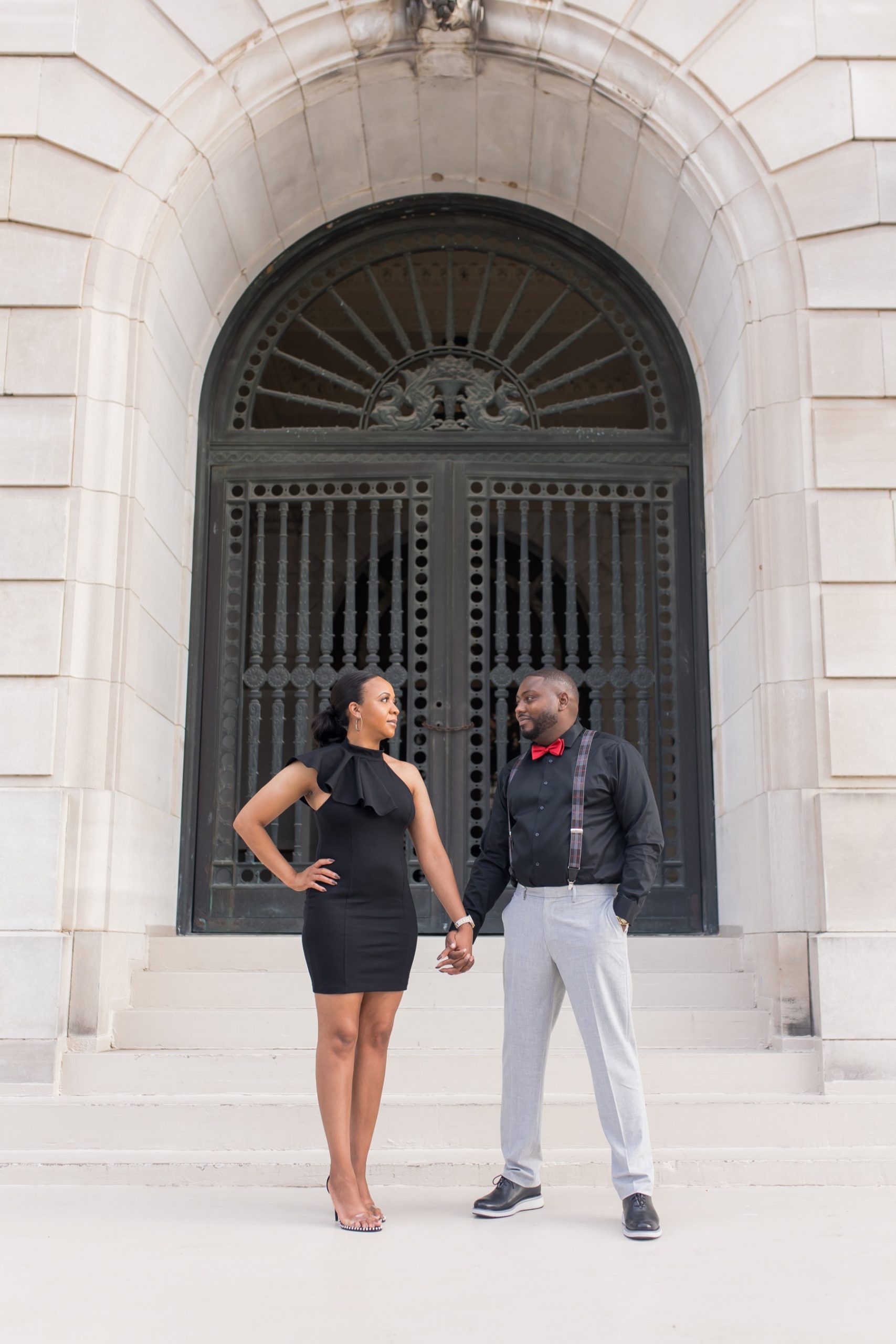 woman and man looking at each other during their downtown little rock engagement session