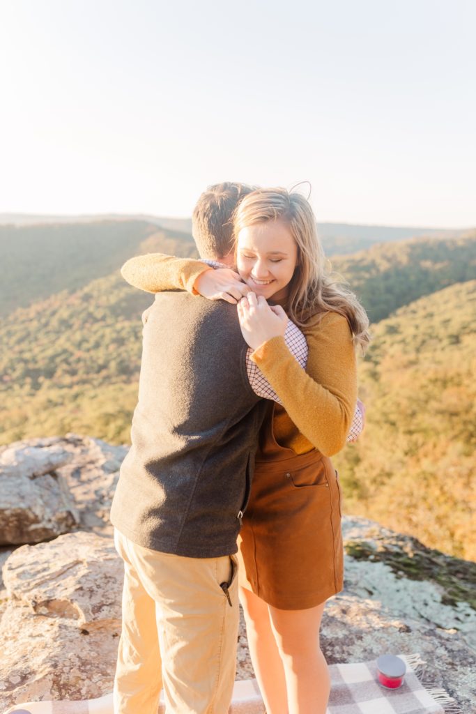 woman hugging man at white rock mountain arkansas during proposal