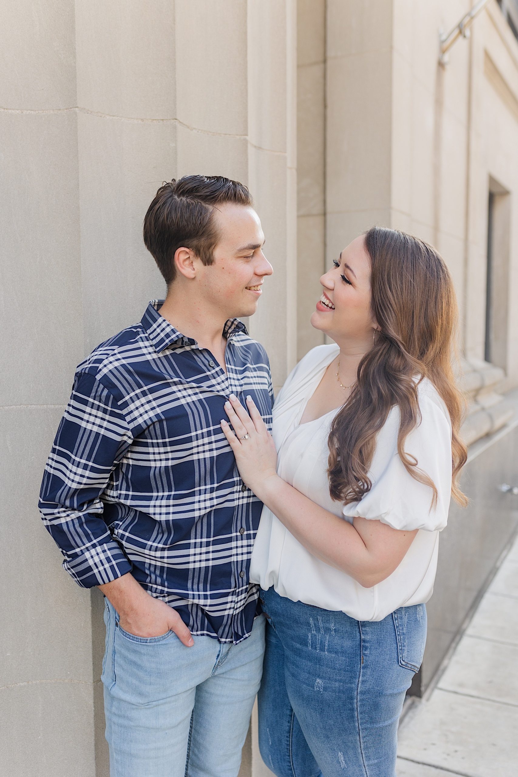 man and woman smiling at each other during their downtown memphis engagement session